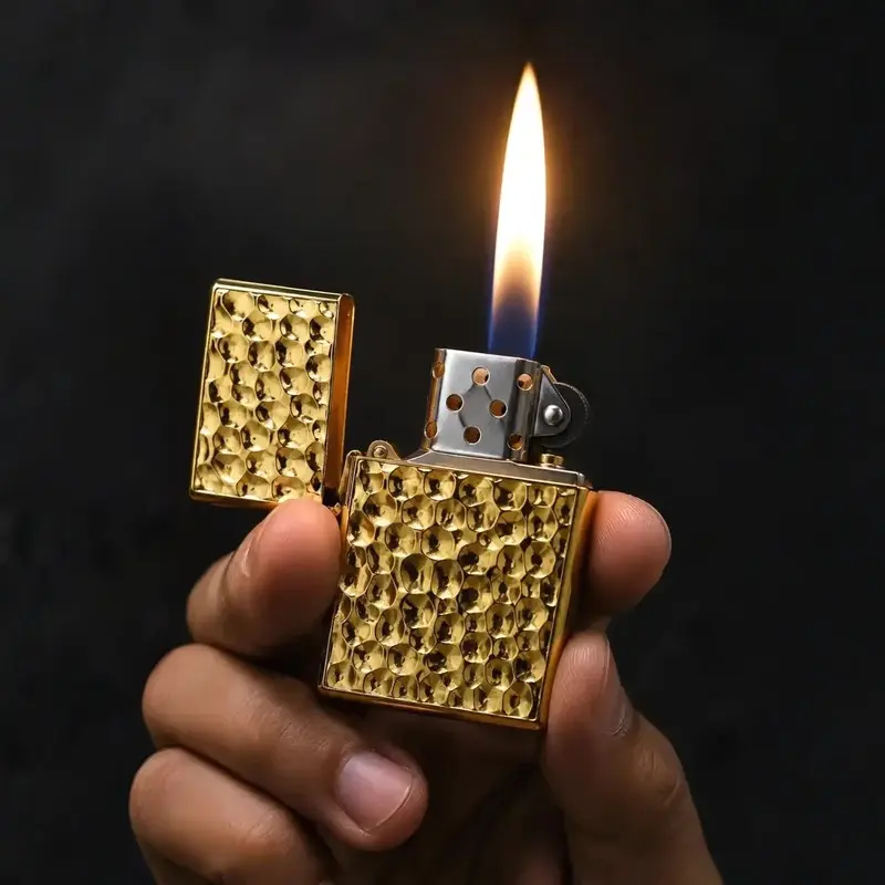 Hand holding Premium Honeycomb Metal Lighter with soft flame